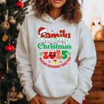 White hoodie with Family Christmas 2025 design, making memories together text, Santa hat graphic, Christmas tree background