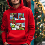 Red hoodie with comic-style grinch christmas printed panels against blurred christmas tree background