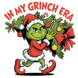 Cartoon Grinch in Santa outfit carrying decorated Christmas tree with ornaments and holly