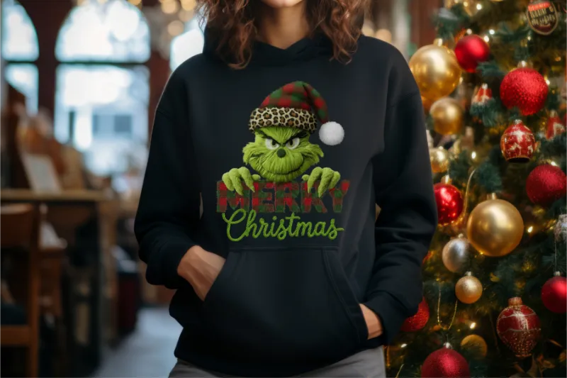 Black hoodie with Grinch-themed Christmas design featuring green character wearing leopard santa hat