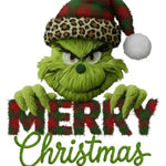 Green Grinch character in leopard-print Santa hat holding 'Merry Christmas' plaid text