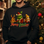 Black hoodie with Merry Grinchmas design featuring Grinch, Max, and Cindy Lou Who characters near Christmas tree