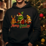 Black hoodie with Merry Grinchmas design featuring Grinch, Max, and Cindy Lou Who characters near Christmas tree