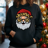 Black hoodie with glittery red leopard print Santa Claus design, Christmas tree ornaments in background