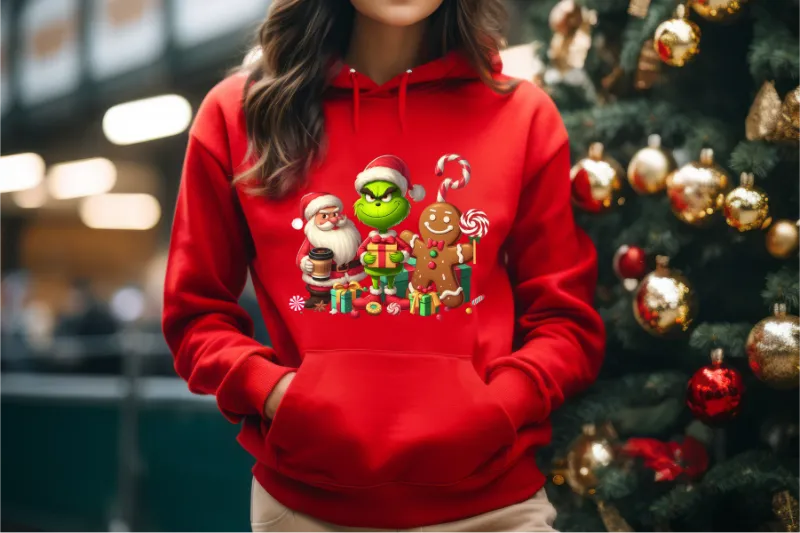 Red hoodie with Christmas characters featuring Grinch, Santa, and gingerbread man printed design