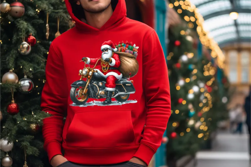 Red hoodie with Santa Claus riding motorcycle, carrying gifts, Christmas tree and lights in background