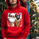 Red hoodie with graphic of Santa and rapper wearing gold chains and sunglasses near Christmas tree
