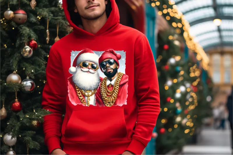 Red hoodie with graphic of Santa and rapper wearing gold chains and sunglasses near Christmas tree