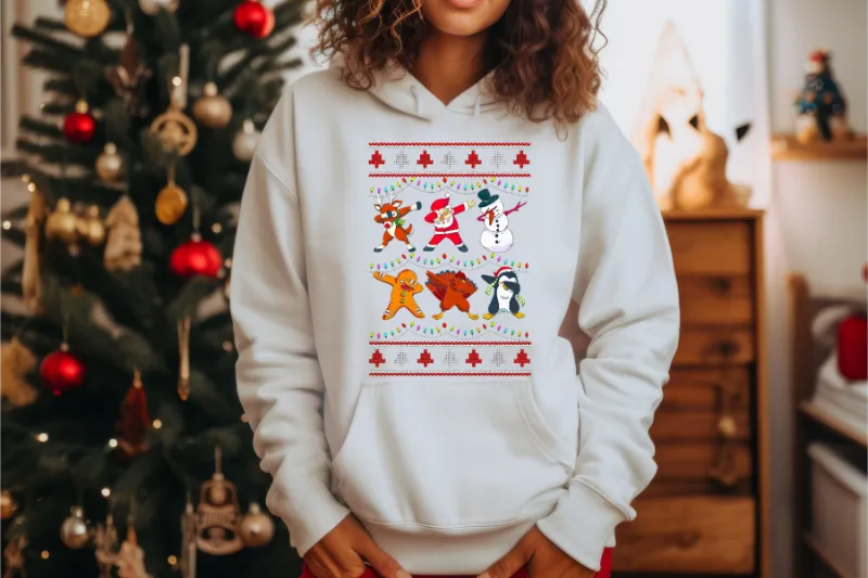 White hoodie with Christmas-themed graphic featuring dancing Santa, reindeer, snowman, and penguin characters