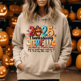 Beige hoodie with 2025 Thanksgiving Crew design, surrounded by carved jack-o-lantern pumpkins