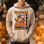 Beige hoodie with Thanksgiving Cruise 2025 graphic, surrounded by orange pumpkins