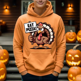 Orange hoodie with cartoon turkey holding Eat Pizza sign, surrounded by carved Halloween pumpkins