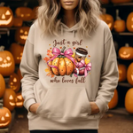 Beige hoodie with autumn-themed graphic featuring pumpkin, pink bow, and coffee cup with text Just a girl who loves fall