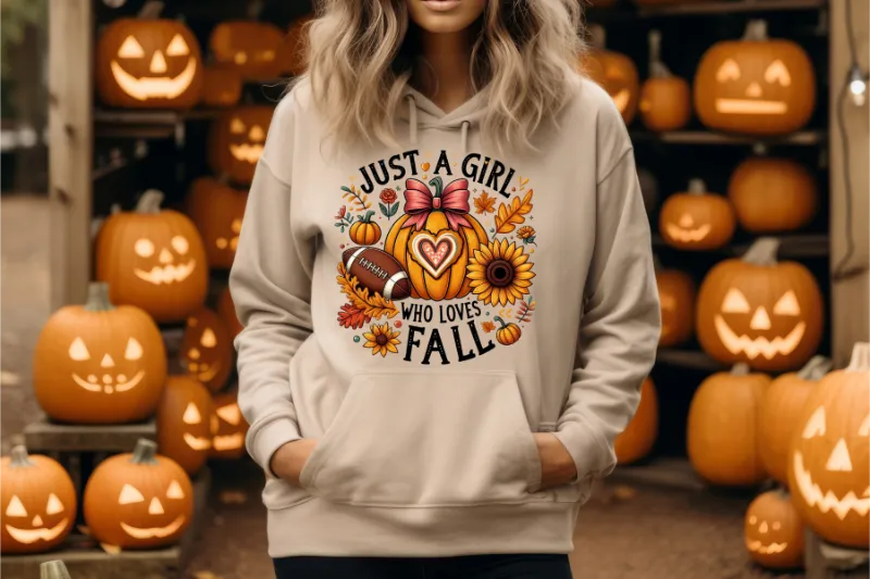 Beige hoodie with Just a Girl Who Loves Fall design featuring pumpkin, sunflower, autumn leaves, and football