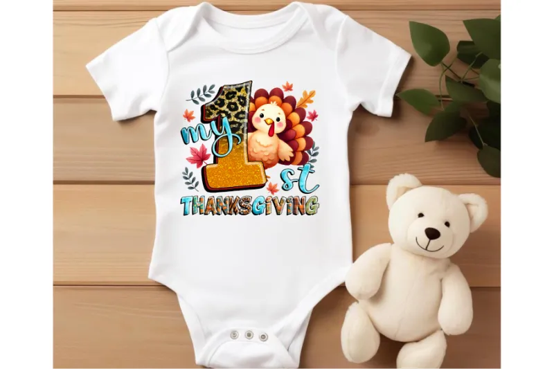 White baby onesie with colorful My 1st Thanksgiving design featuring turkey, leopard number 1, and autumn leaves
