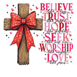 Wooden cross with red heart-patterned bow, inspirational religious text about believing, trusting, hoping, seeking, worshiping, and loving